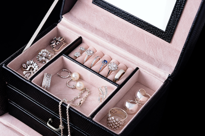 Jewelry box with white gold and silver rings, earrings and pendants with pearls. Collection of luxury jewelry.
